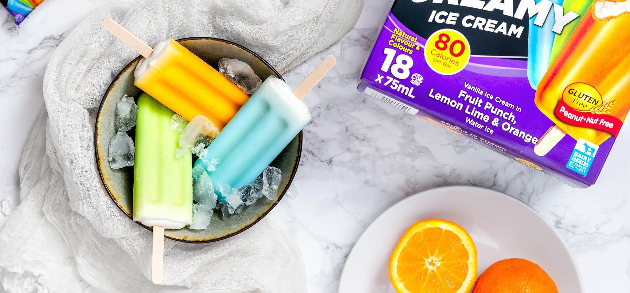 Chapman's Fruit Punch, Lemon Lime and Orange Super Creamy options in a bowl over ice