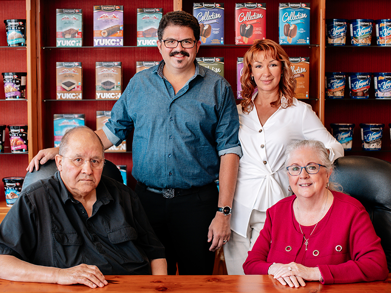 The Chapman family gathered together for a photo in front of a display of Chapman's products.
